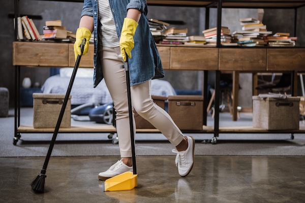 Sweeping dirt off floor in office setting