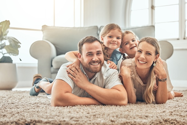 Family laying on clean carpets and rugs in the living room